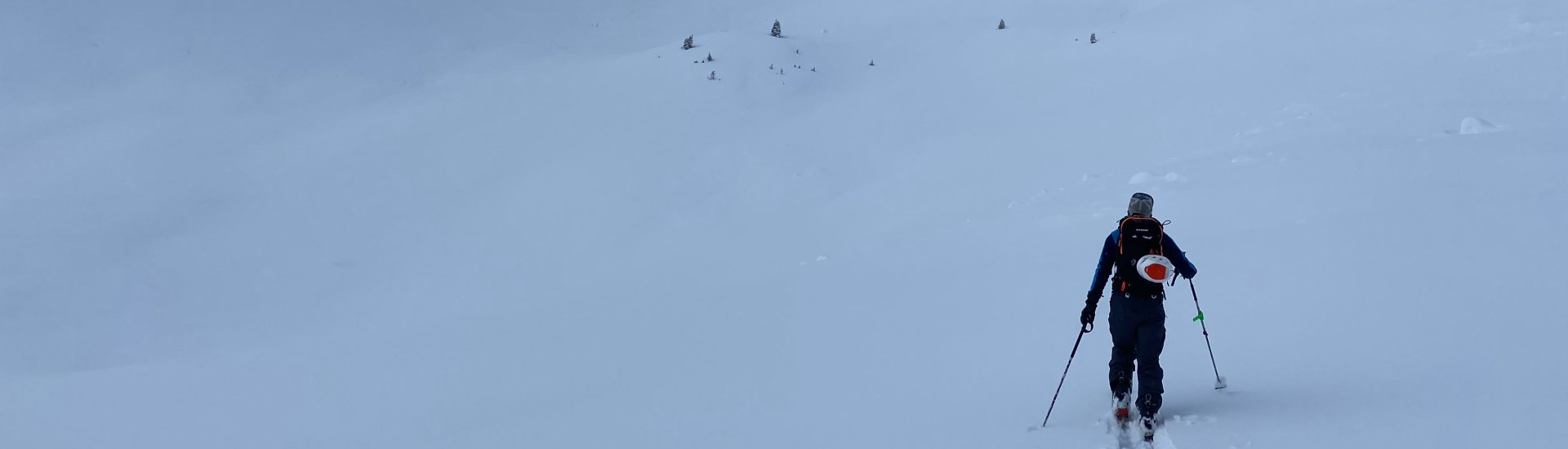 Adam Butterfield skinning up a mountain